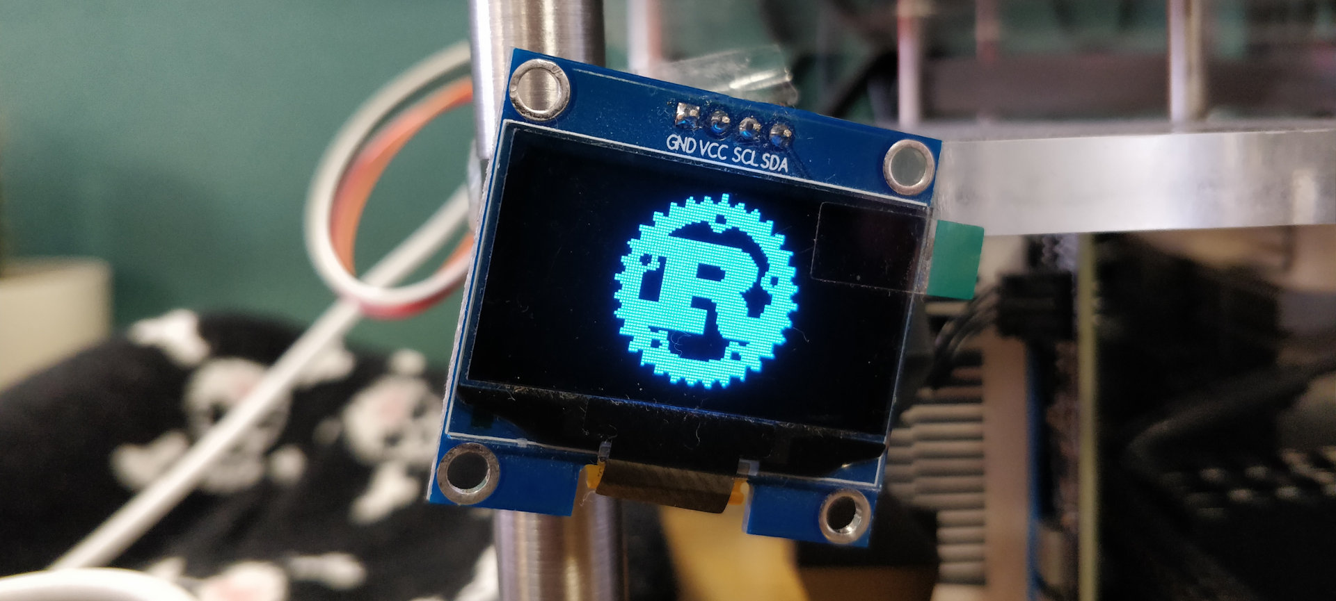 SH1106 display module showing the Rust logo