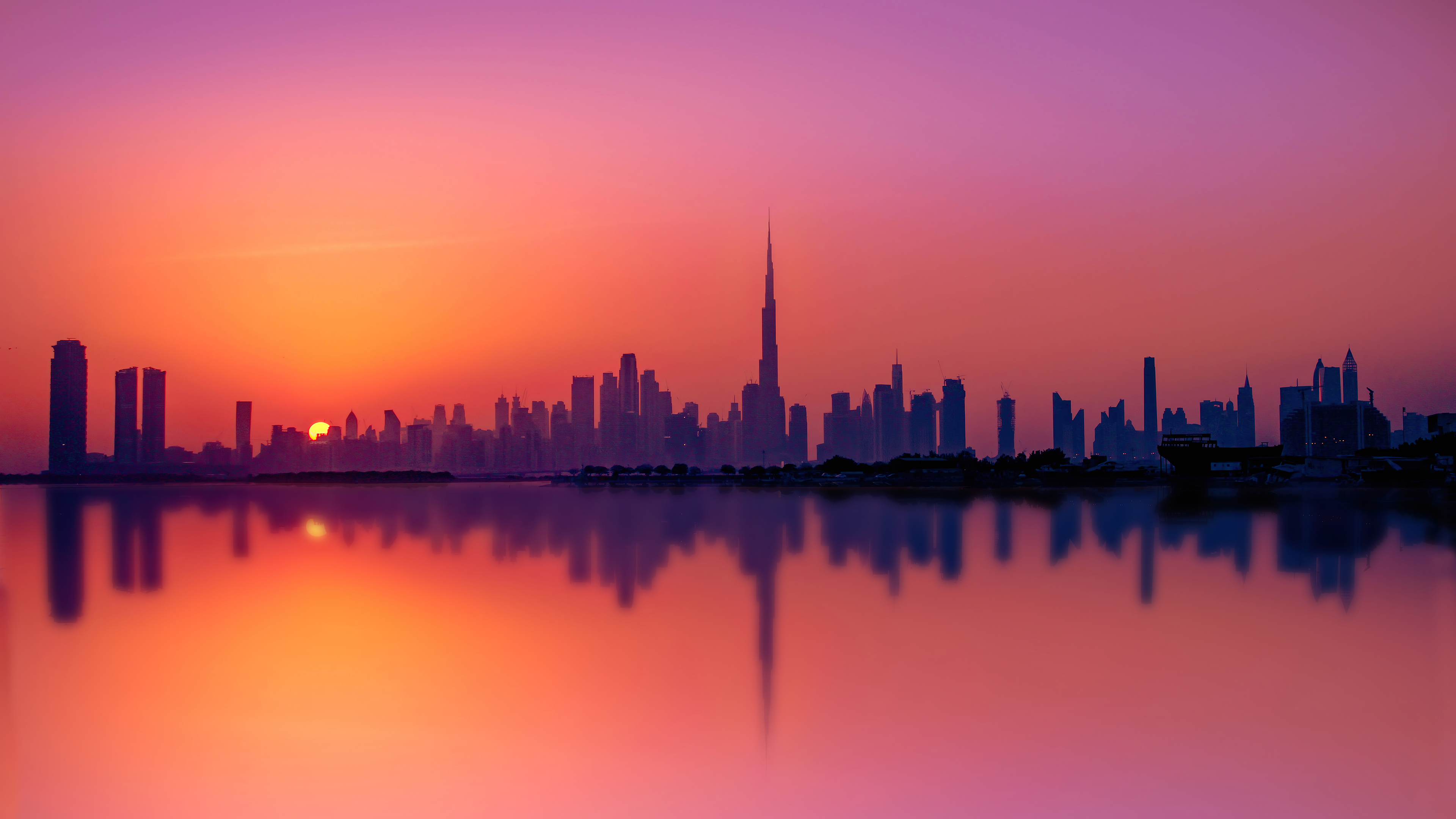 a_city_skyline_with_a_sunset_behind_it