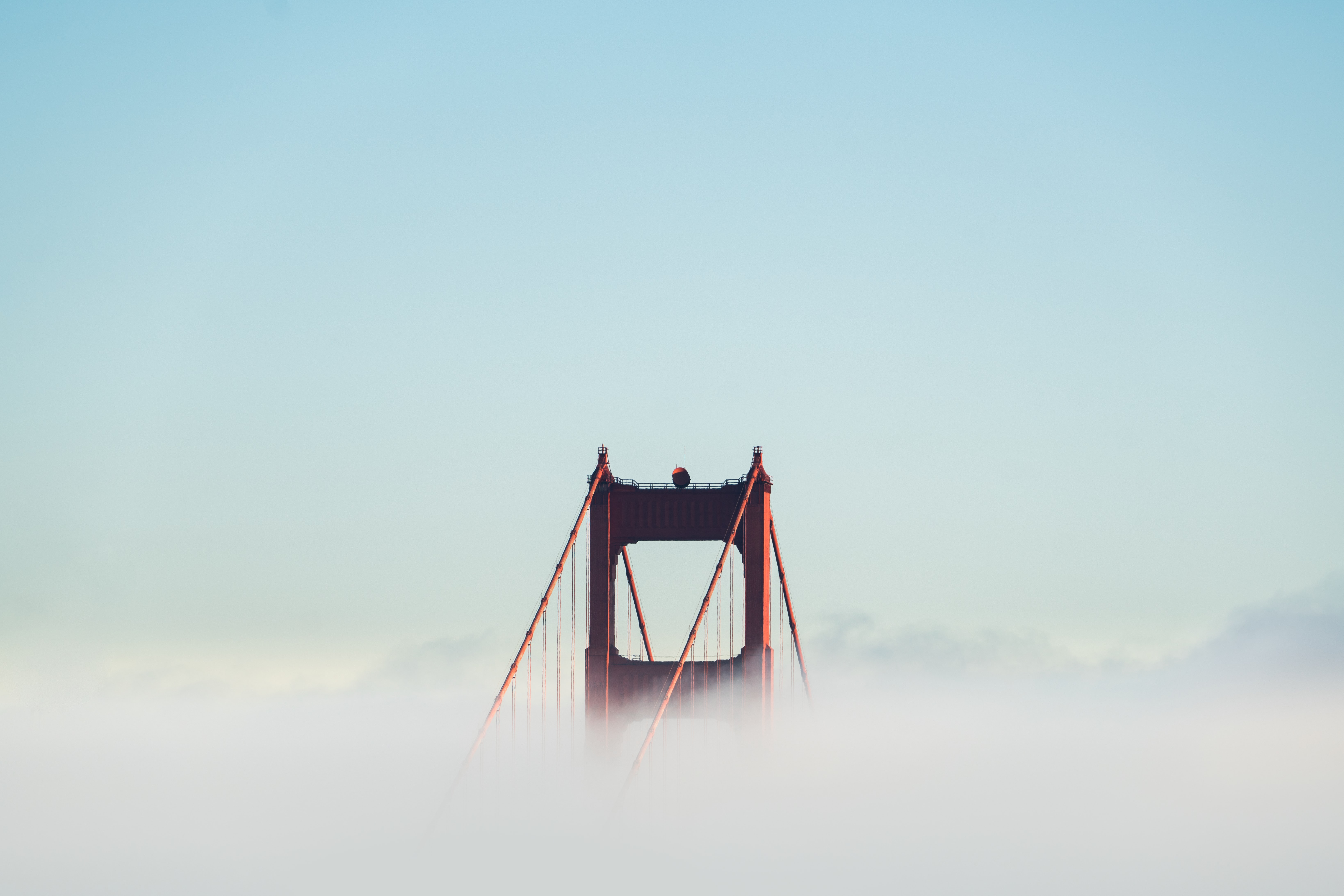 a_bridge_with_clouds_in_the_sky