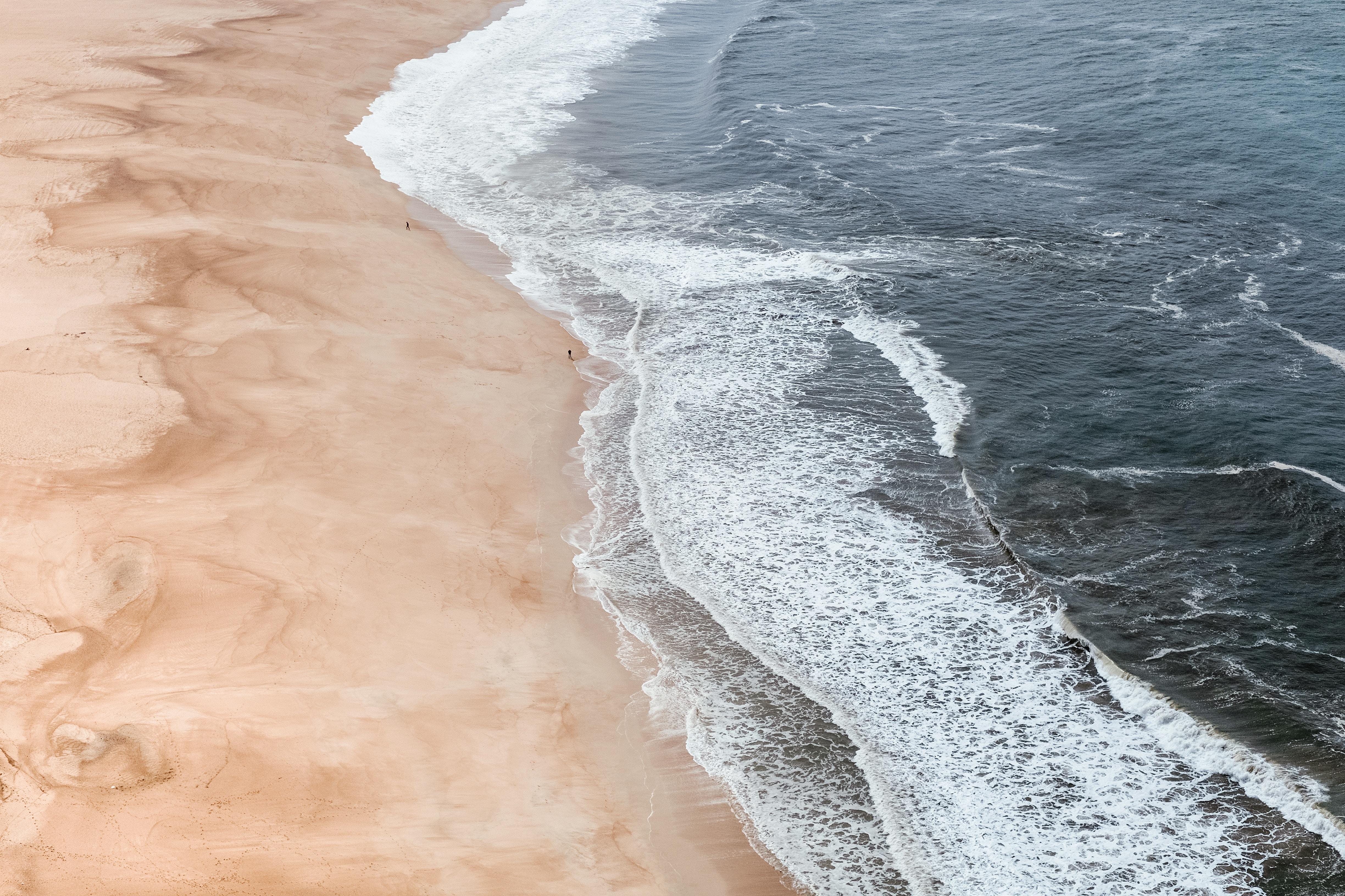 a_beach_with_waves_crashing_on_the_shore