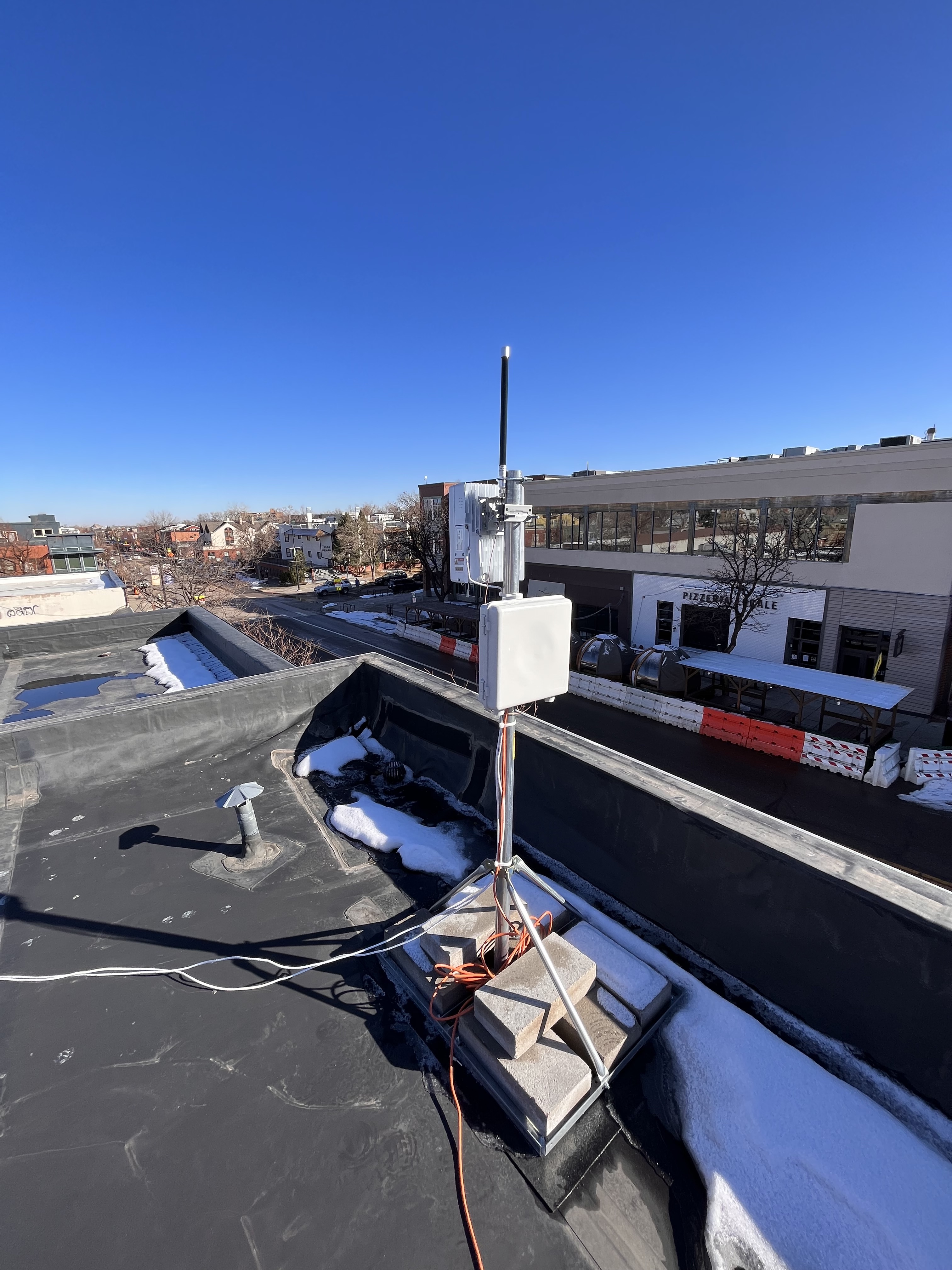 Figure 3. A Baicells Outdoor Radio 430 installed on a two-story roof.