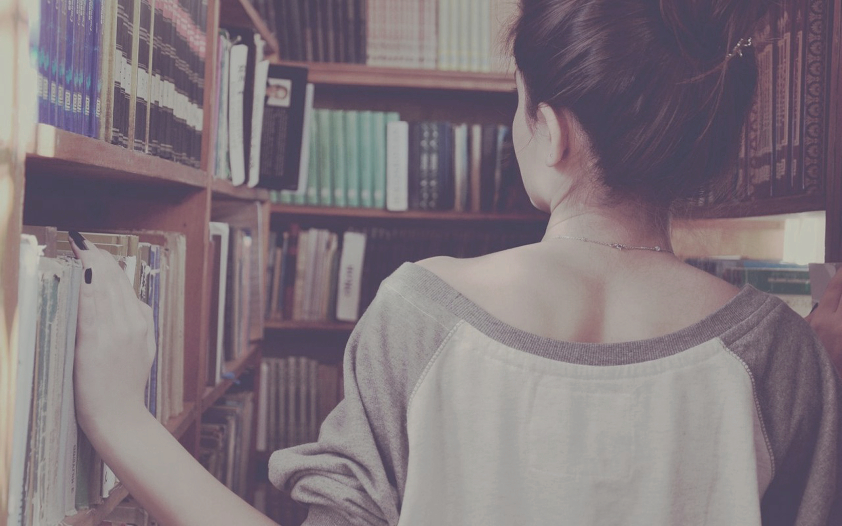 a_woman_standing_in_front_of_a_bookshelf