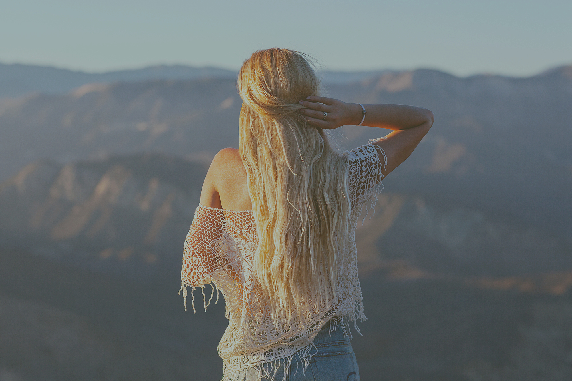 a_woman_standing_on_a_mountain