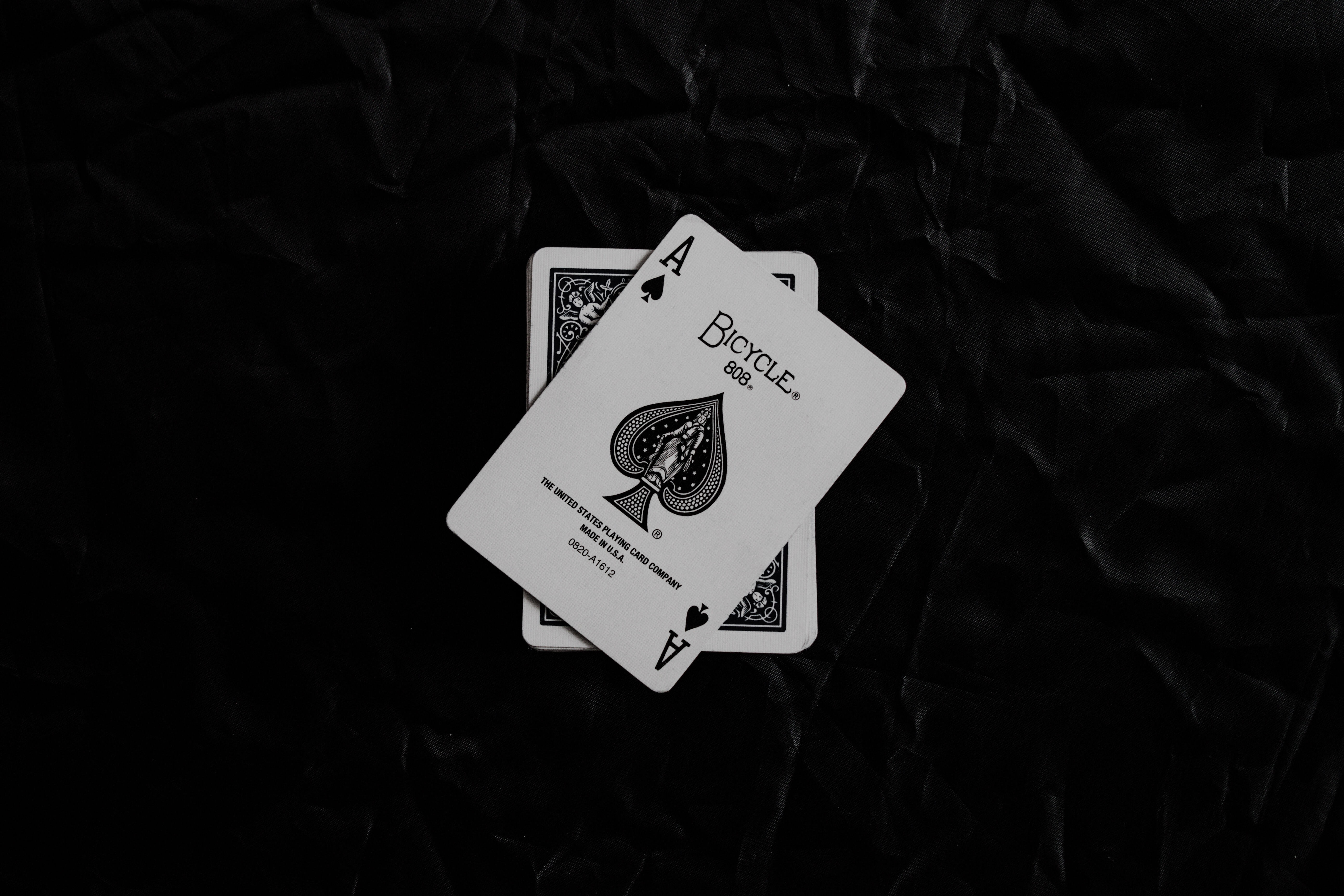 a_pair_of_playing_cards_on_a_black_surface