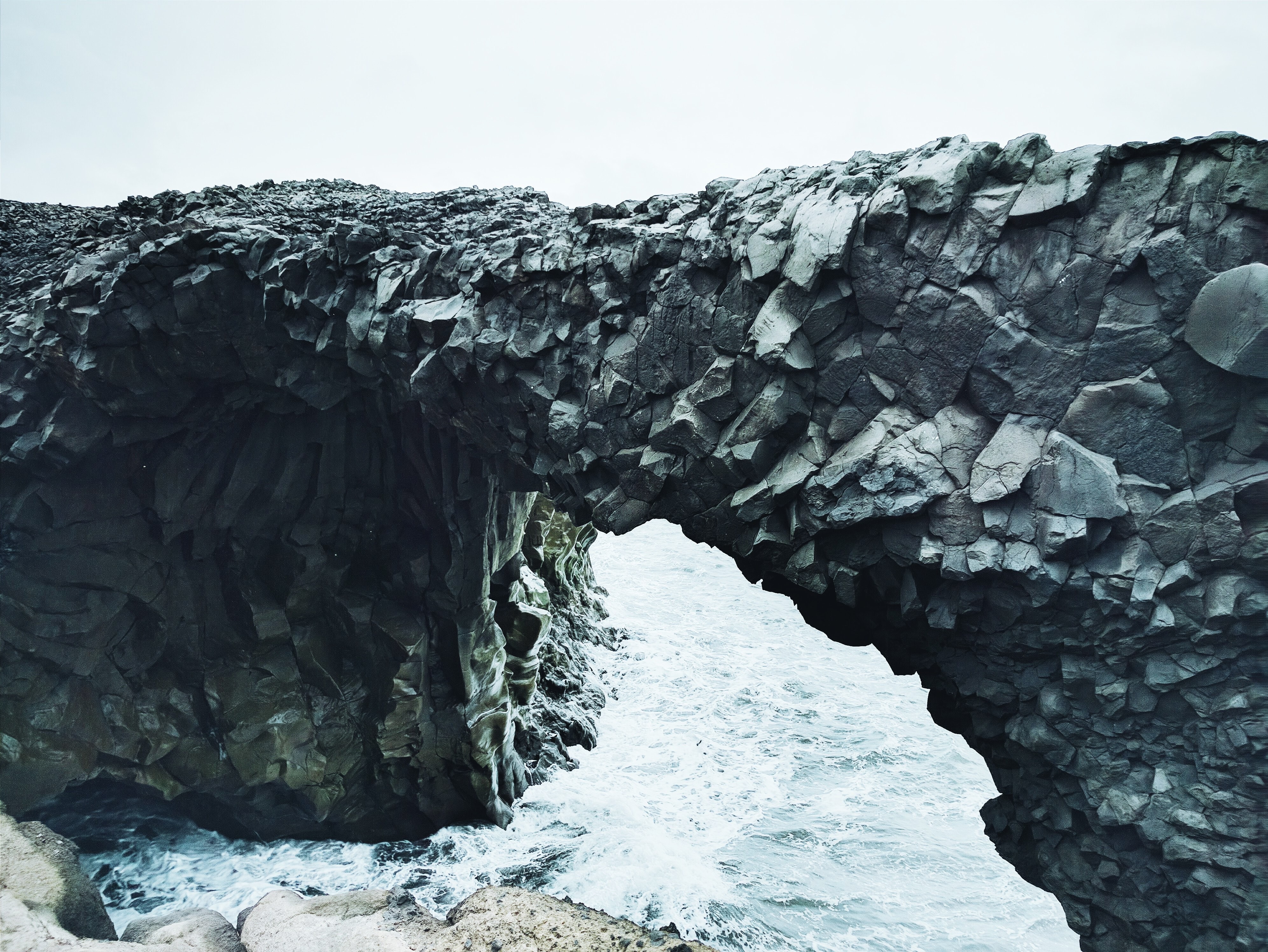 a_rock_arch_over_water