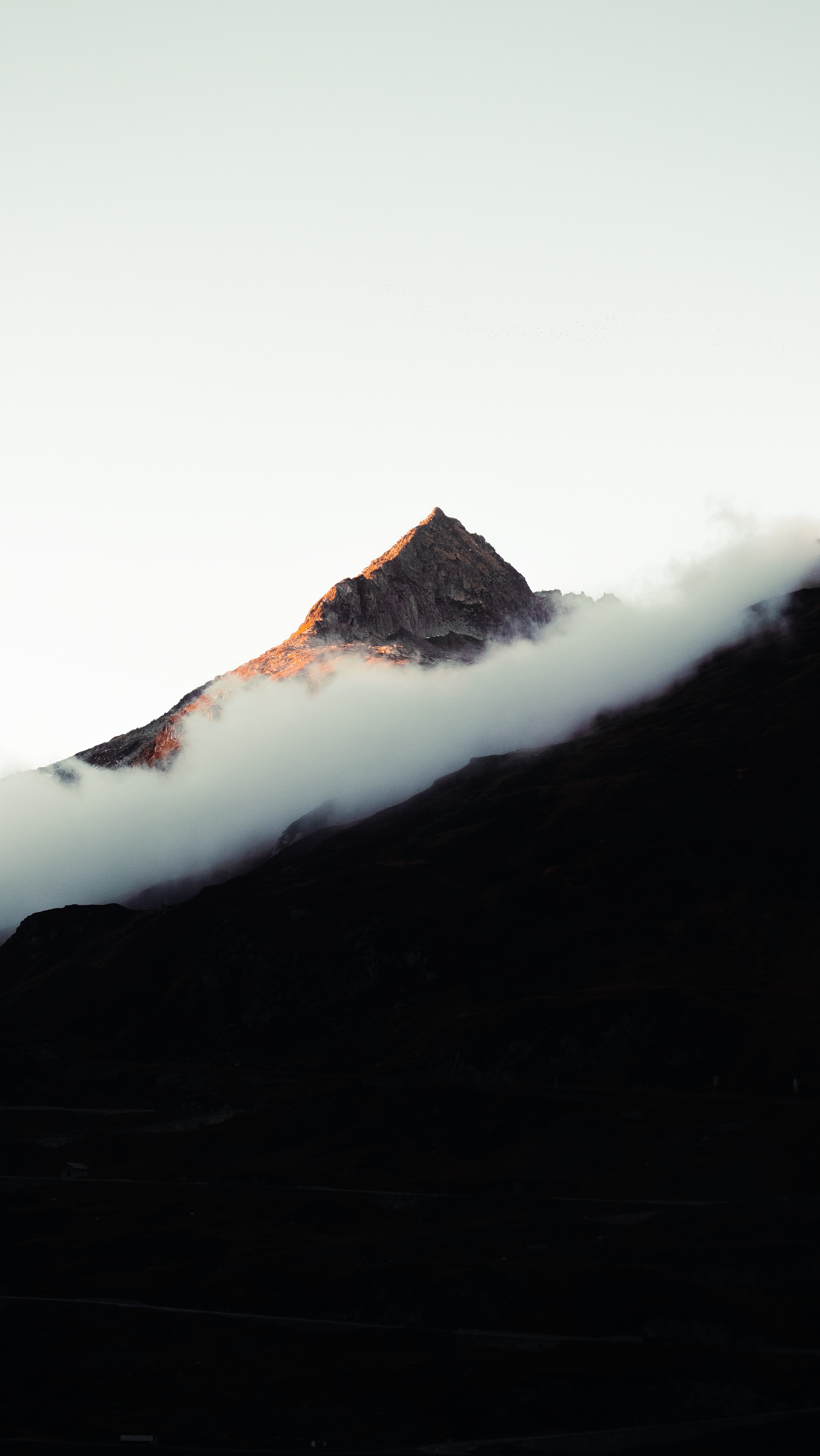 a_mountain_with_clouds_in_the_sky