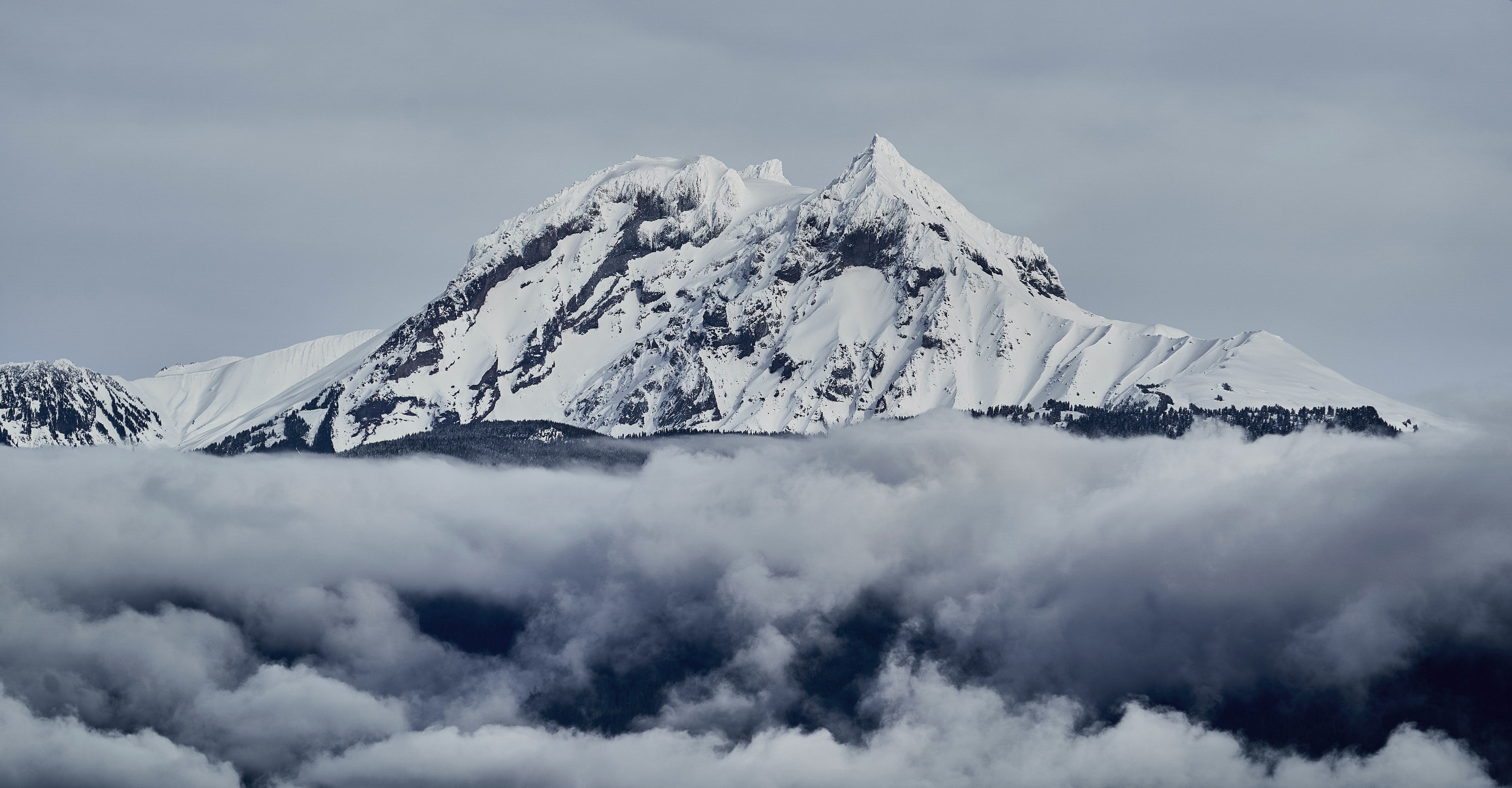 a_mountain_with_snow_and_clouds