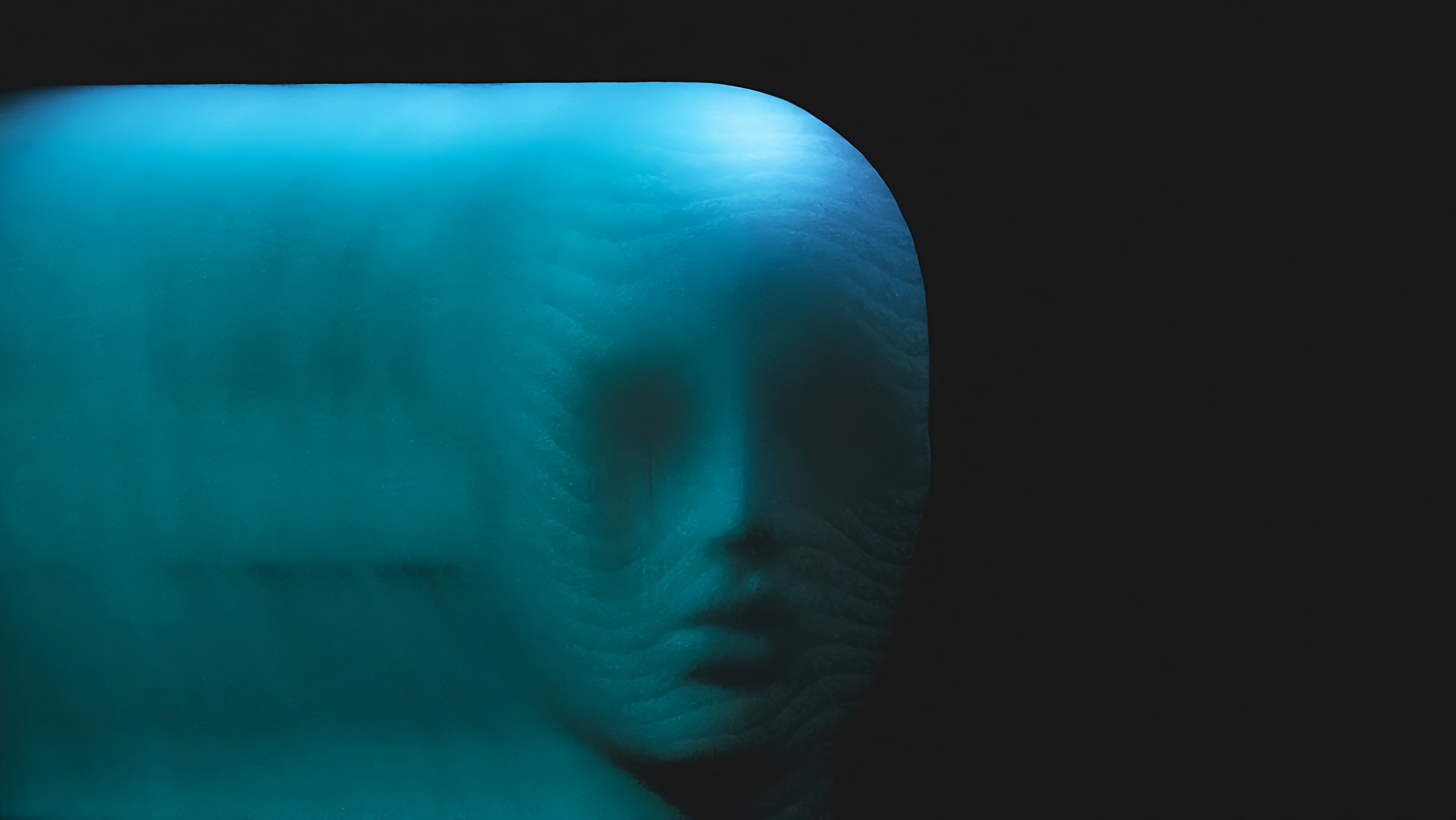 a_face_in_a_blue_light