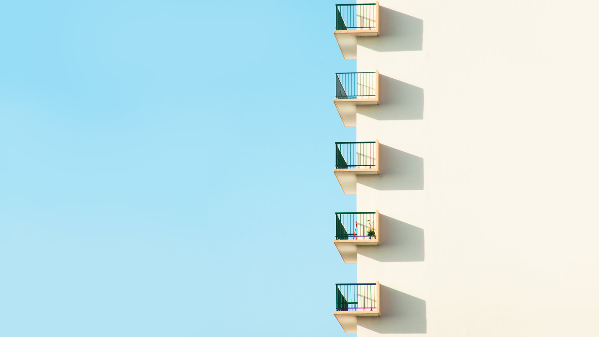 a_white_building_with_balconies