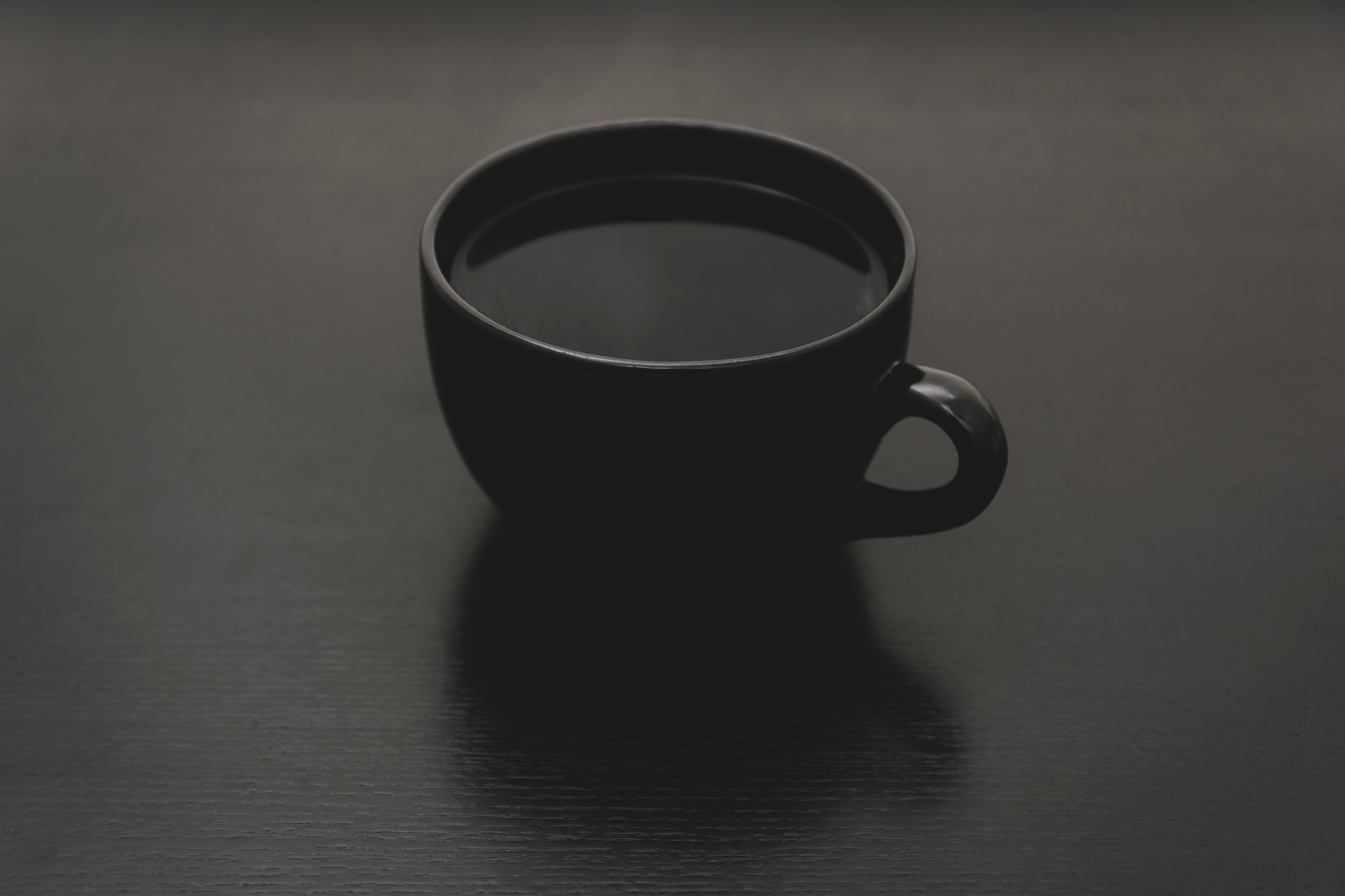 a_black_cup_with_liquid_in_it