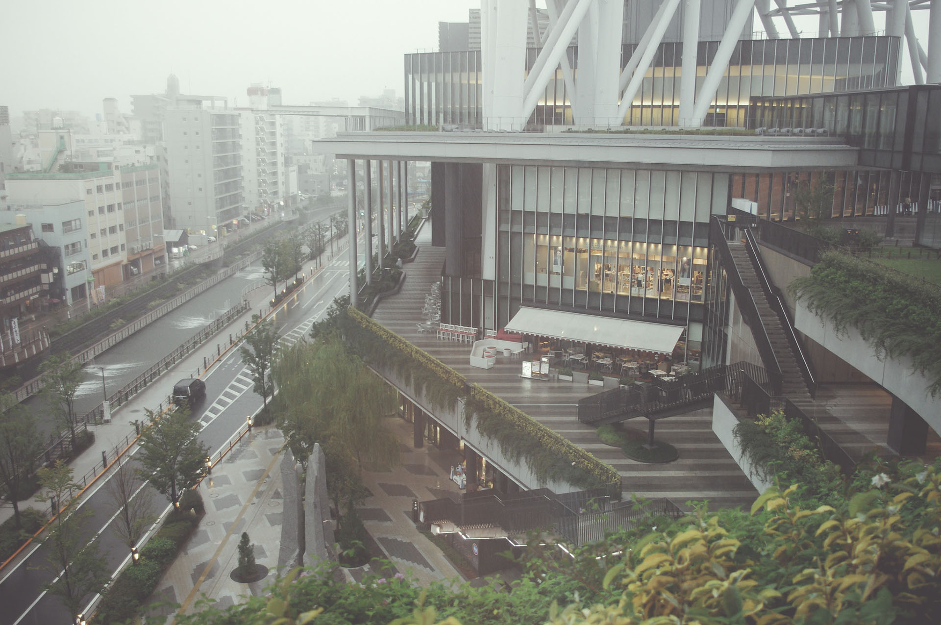 a_building_with_a_walkway_and_trees