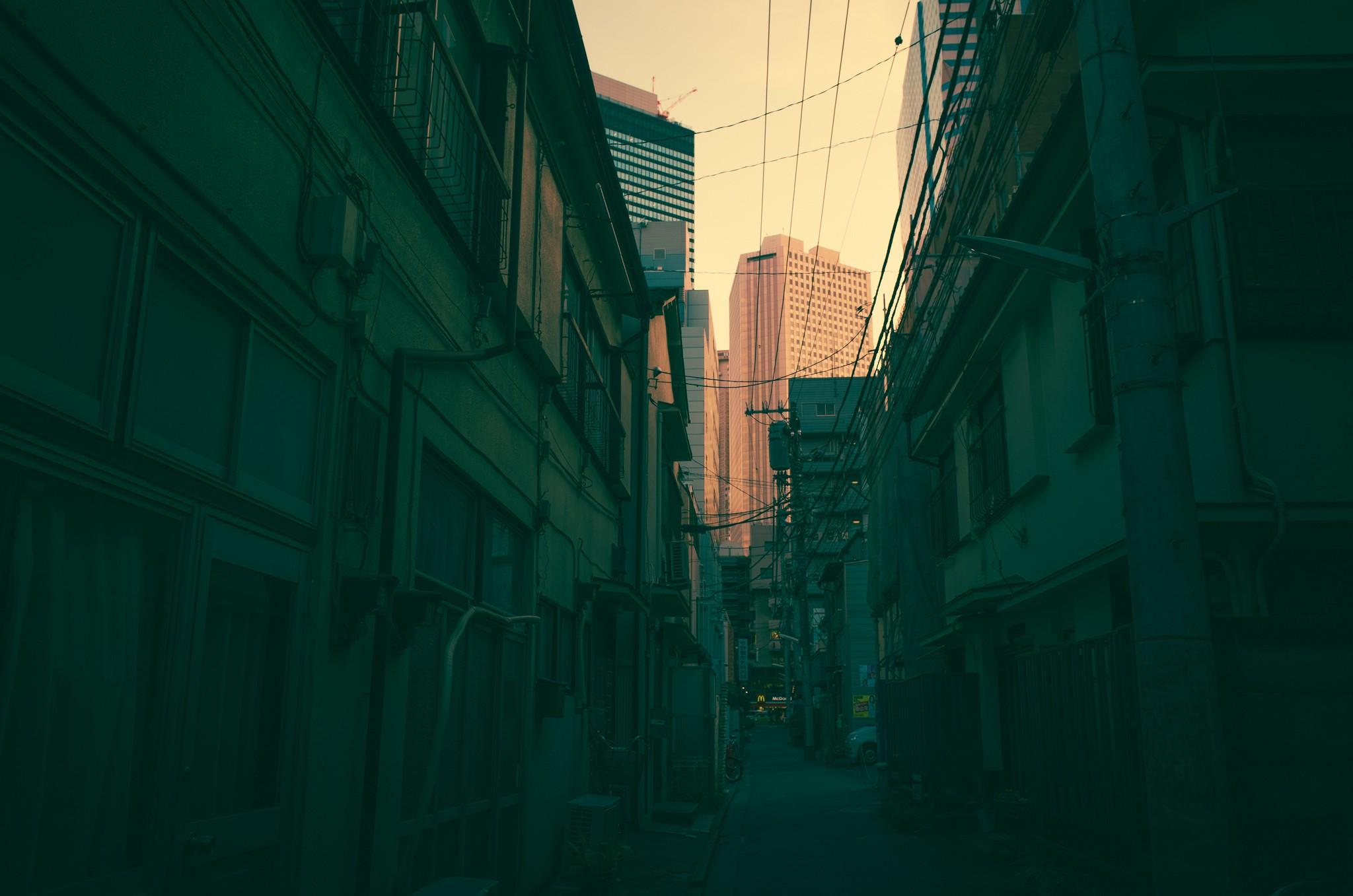 a_city_alley_with_buildings_and_power_lines