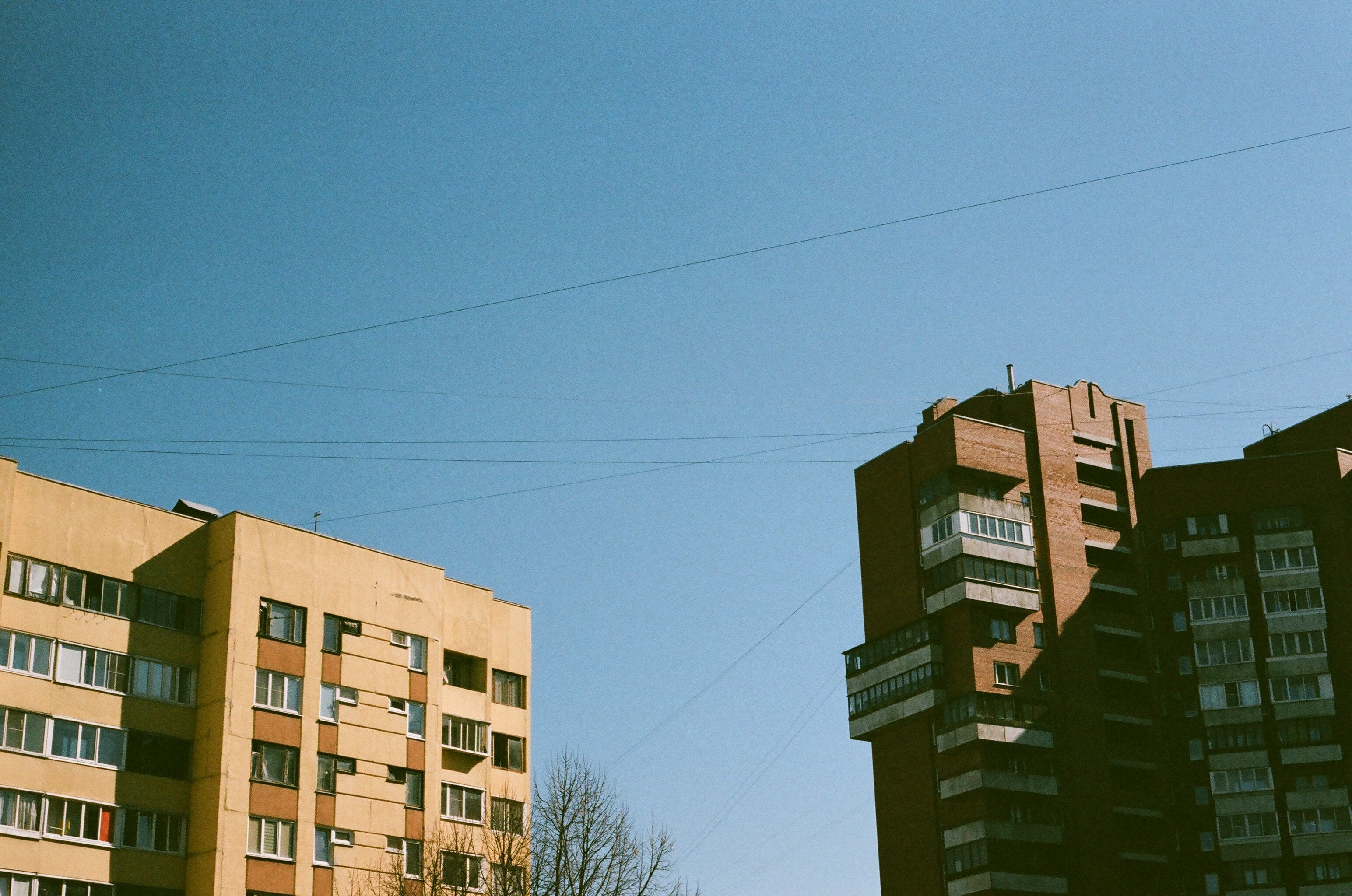 a_tall_buildings_with_power_lines_in_the_sky