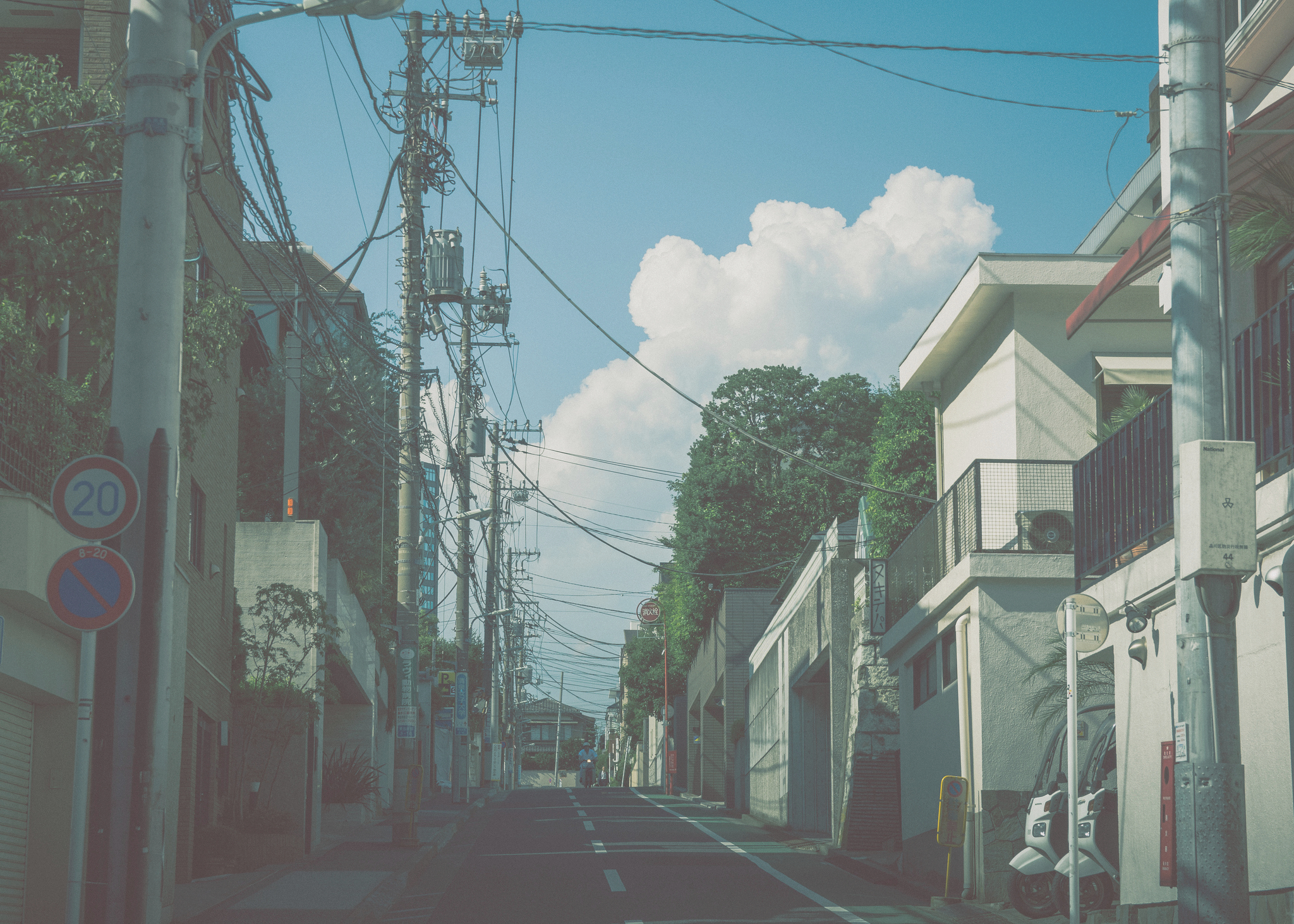 a_street_with_buildings_and_power_lines