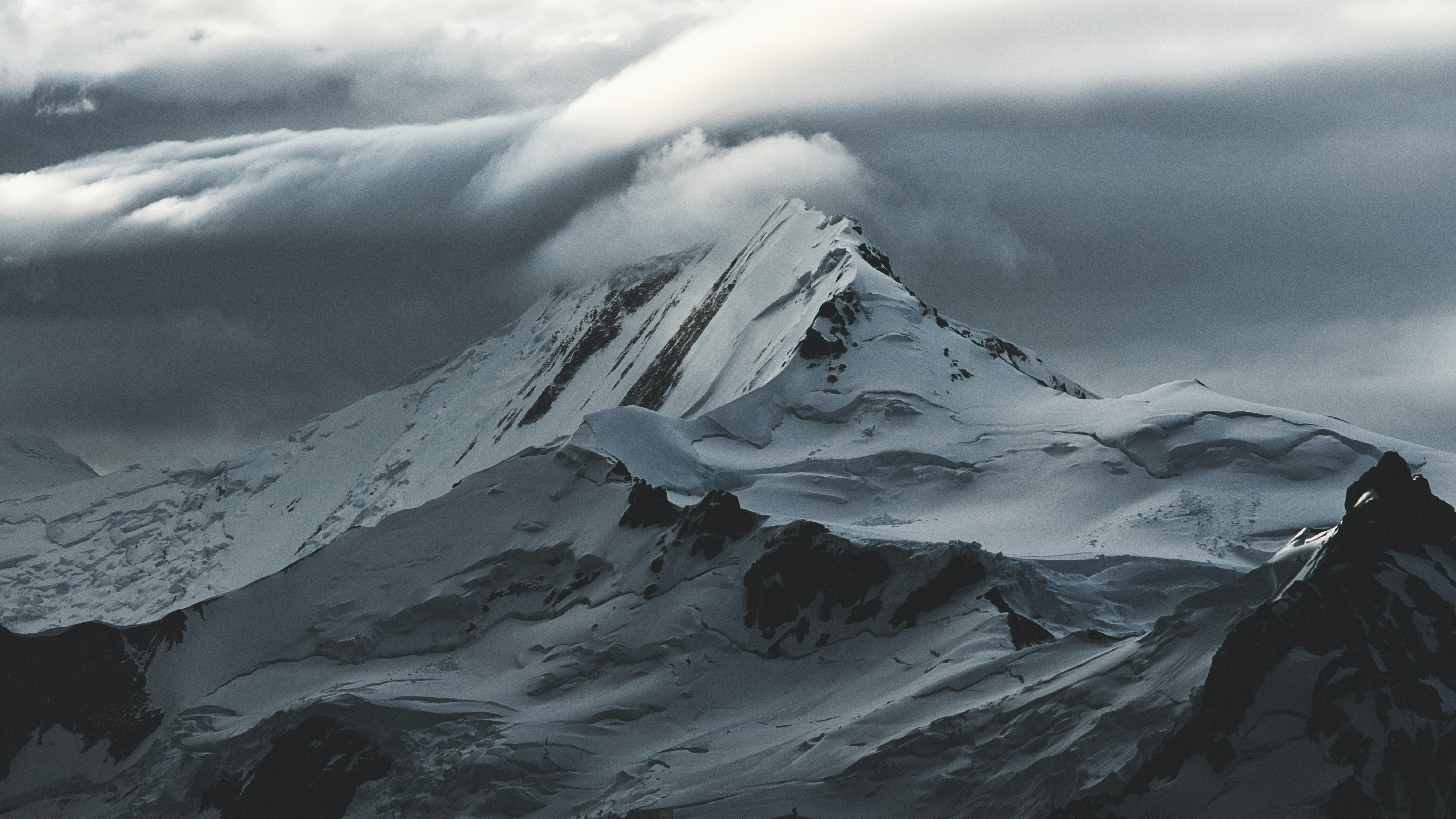 a_snowy_mountain_with_clouds_above