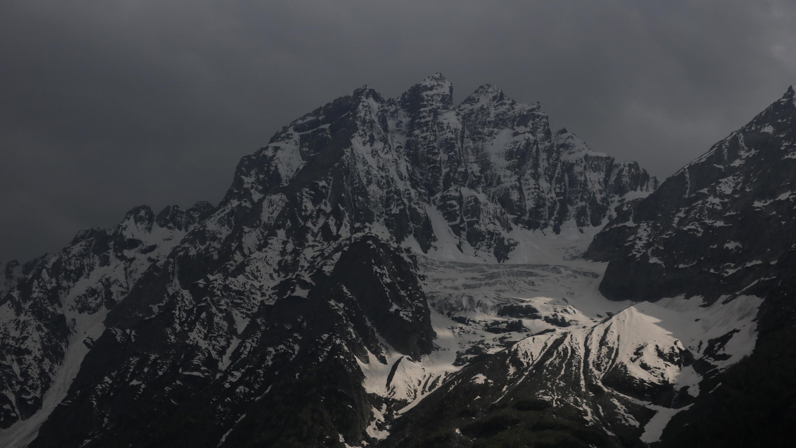 a_snowy_mountain_with_dark_clouds