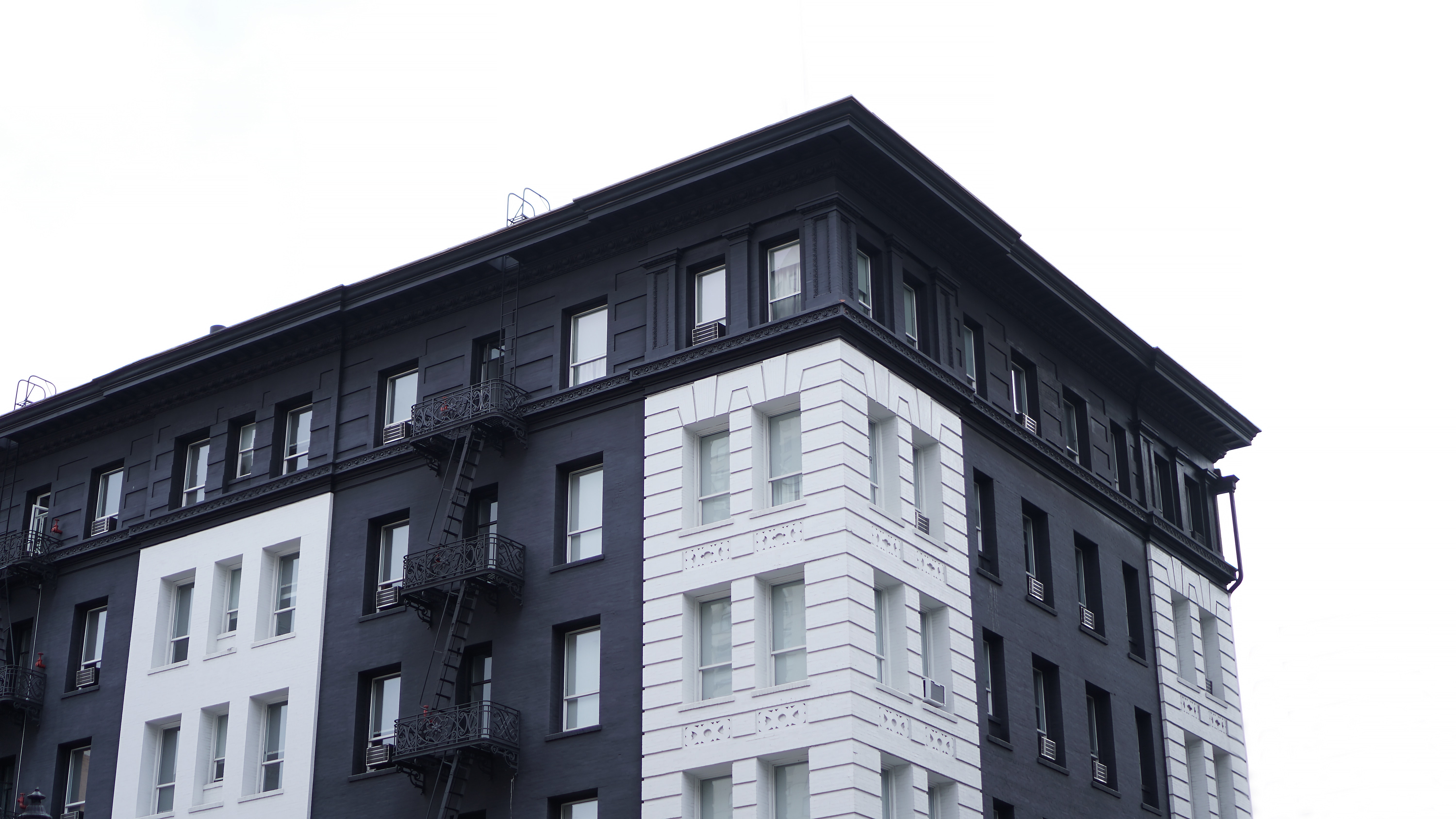 a_black_and_white_building_with_a_fire_escape