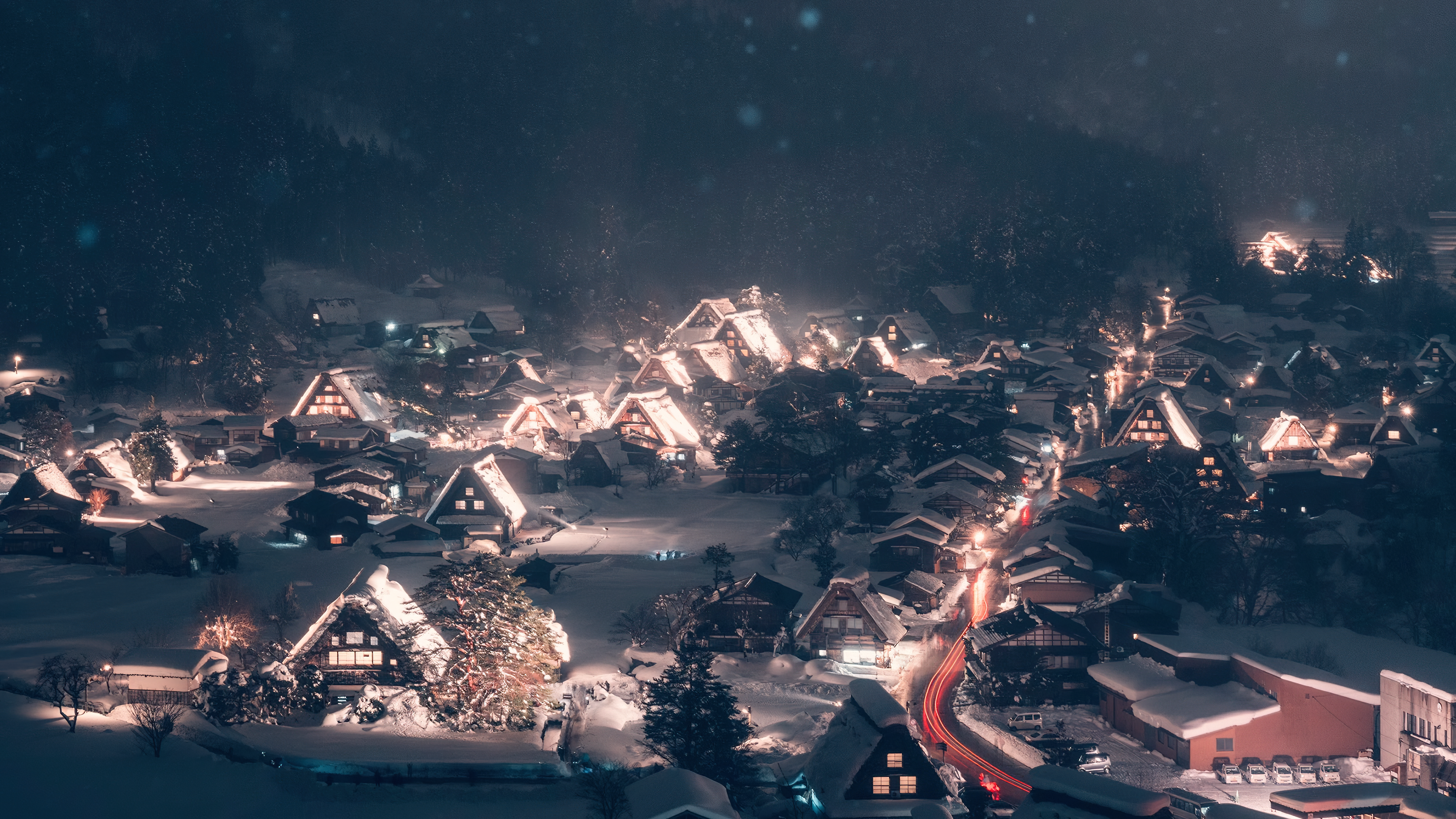 a_town_with_snow_covered_roofs_and_lights