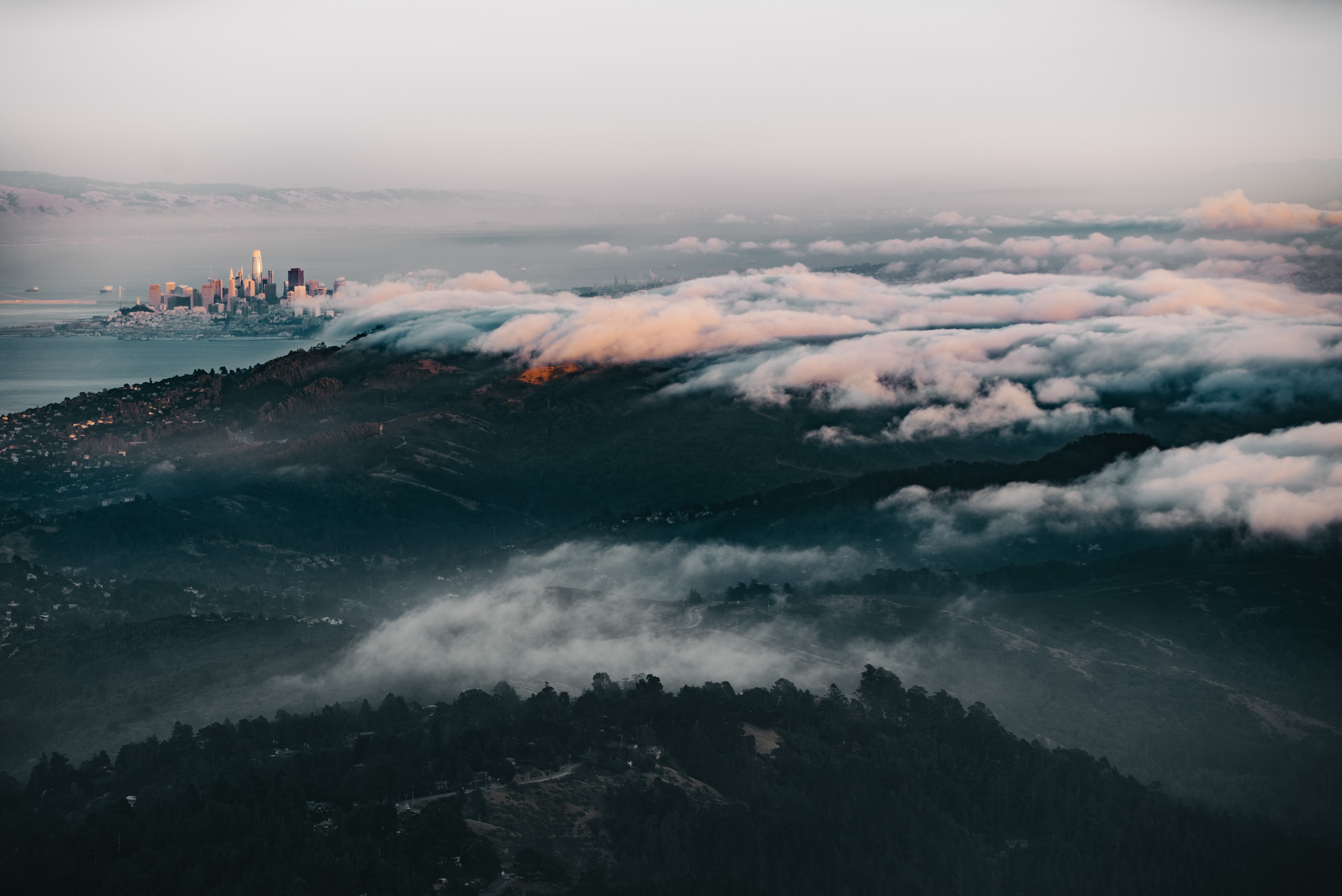 a_city_in_the_distance_with_clouds