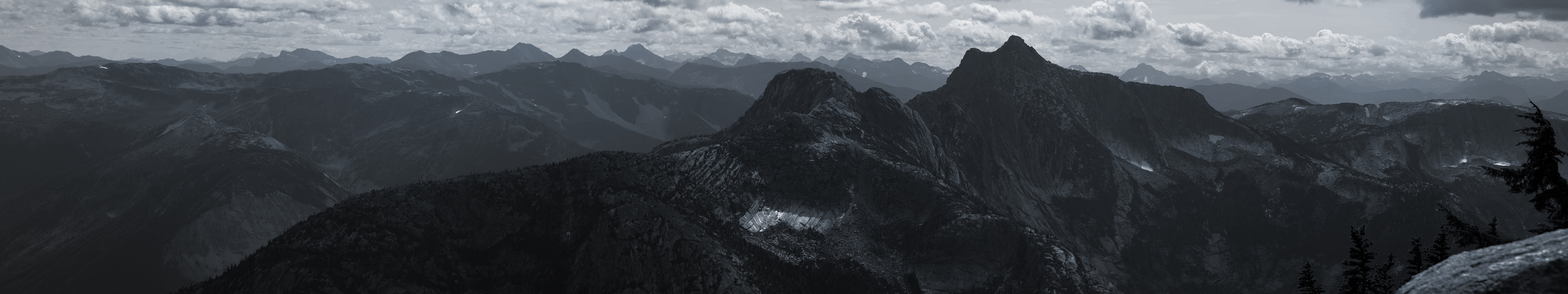 a_mountain_range_with_clouds_in_the_background