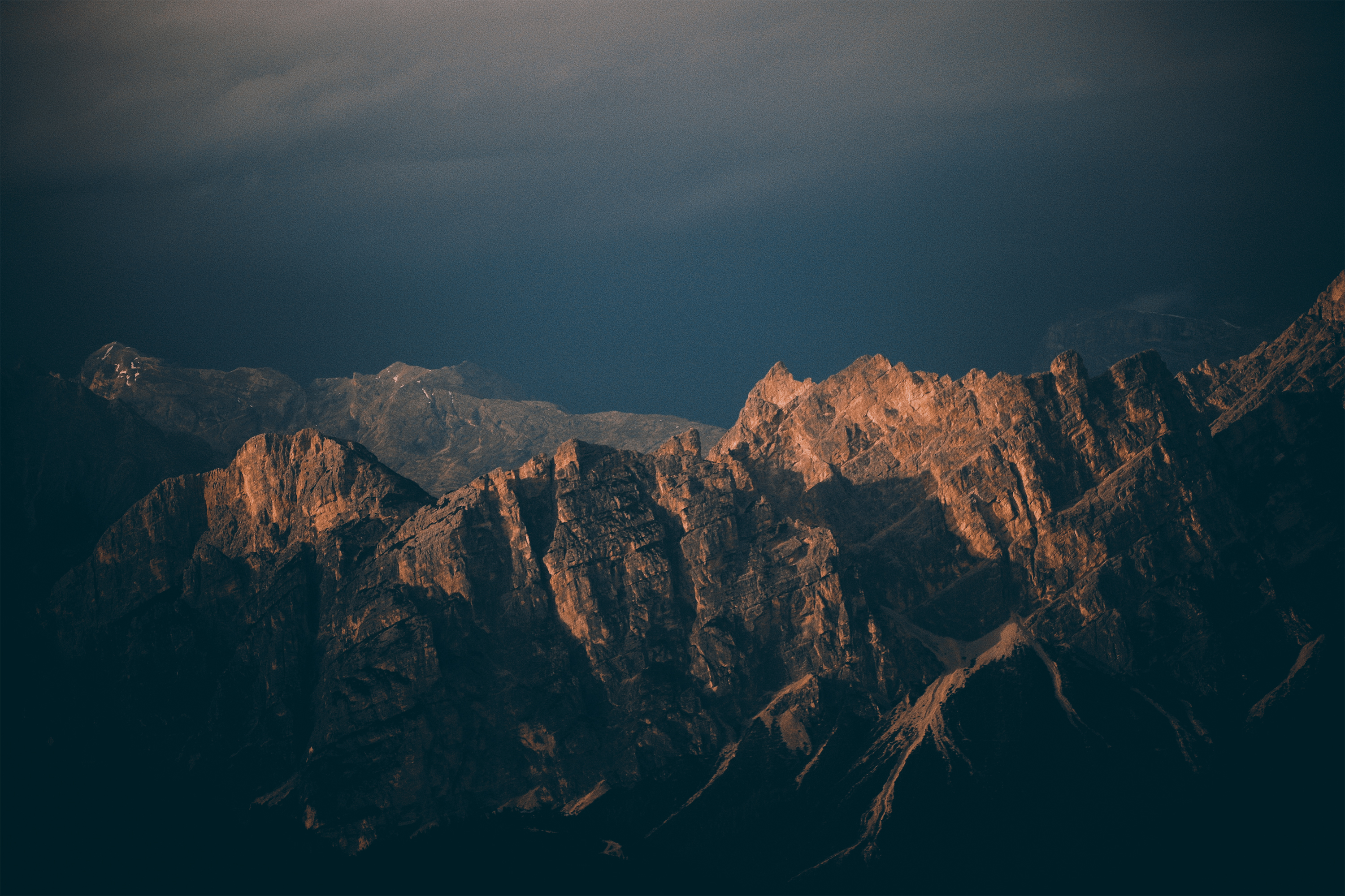 a_mountain_range_with_dark_clouds