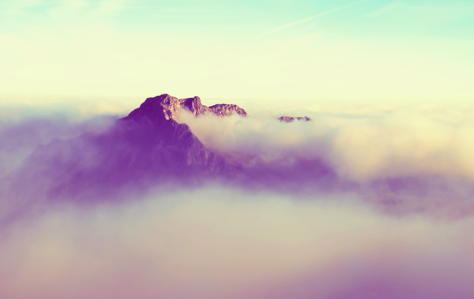 a_mountain_with_clouds_above_it