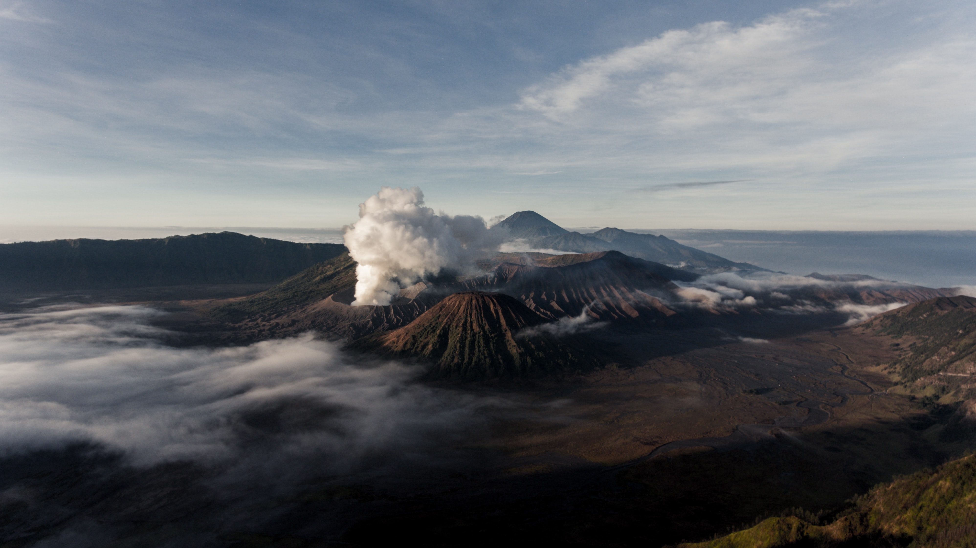 a_mountain_with_smoke_coming_out_of_it